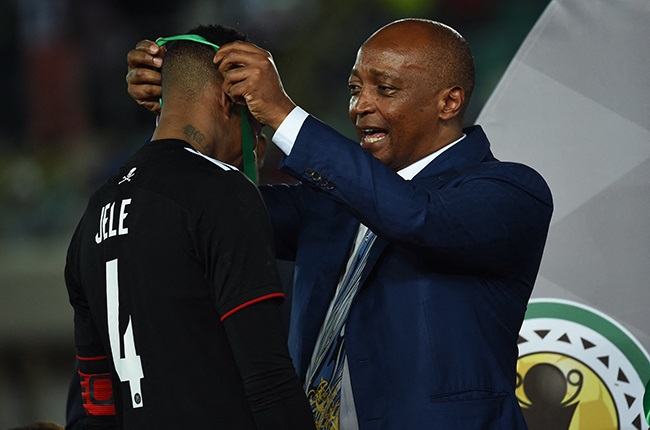 Orlando Pirates, captain Happy Jele (R), is given a medal by CAF President, Patrice Motsepe. (Photo by PIUS UTOMI EKPEI / AFP)