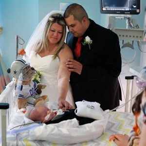 Kristi Warriner, left, and Justin Nelson look on at their son, J.J. after they were married in the neonatal intensive care unit of Cook Children’s Medical Center in Fort Worth, Texas on Tuesday, Nov. 11, 2014