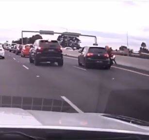 A screengrab from the video showing the Golf crashing into the biker in the fast lane.
