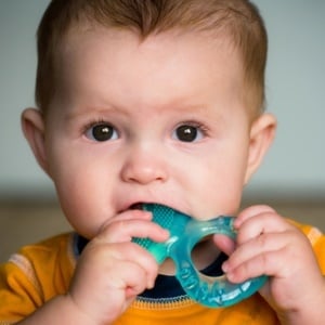 Child with teething toy from Shutterstock