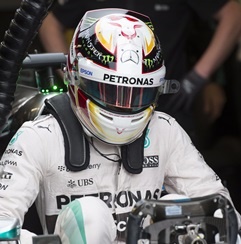 Mercedes driver Lewis Hamilton slips into his car for a practice session in Montreal.   (Paul Chiasson, AP)