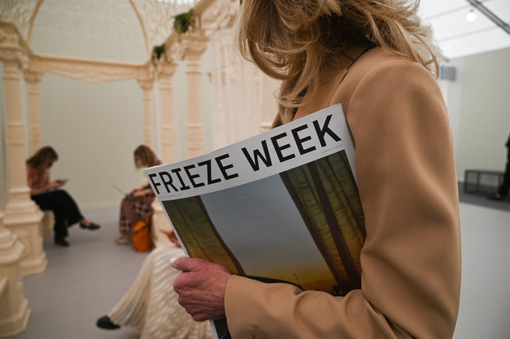 An attendee holds the Frieze Week Magazine on the first day of Frieze Los Angeles, a leading international art fair, February 17, 2022 in Beverly Hills, California. (Robyn Beck / AFP)


