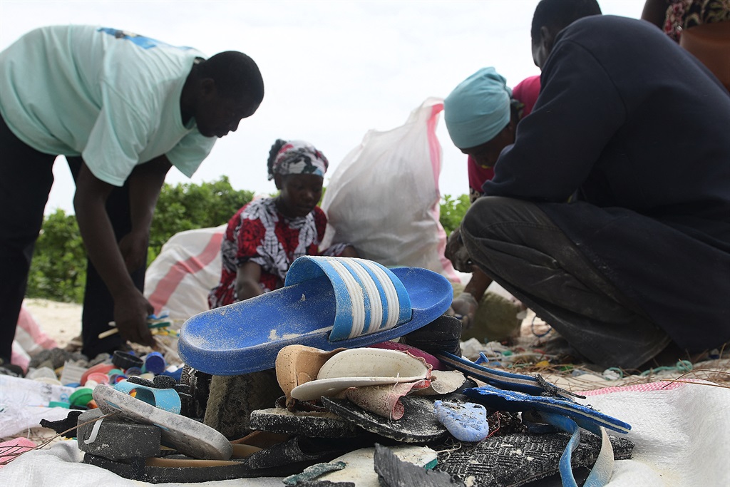 Volunteers sorting collected plastic waste during a cleaning exercise organised by Ocean Sole Africa, in Kilifi county on 12 February, 2022 