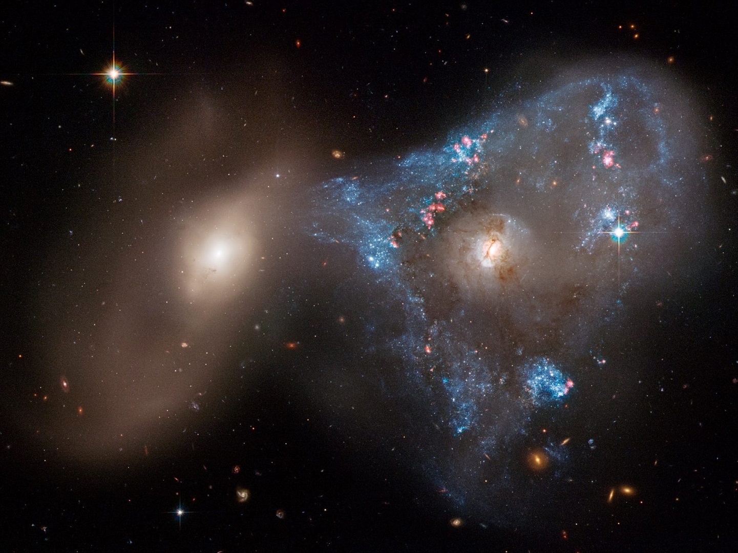 Two galaxies colliding, as photographed by the Hubble Space Telescope.