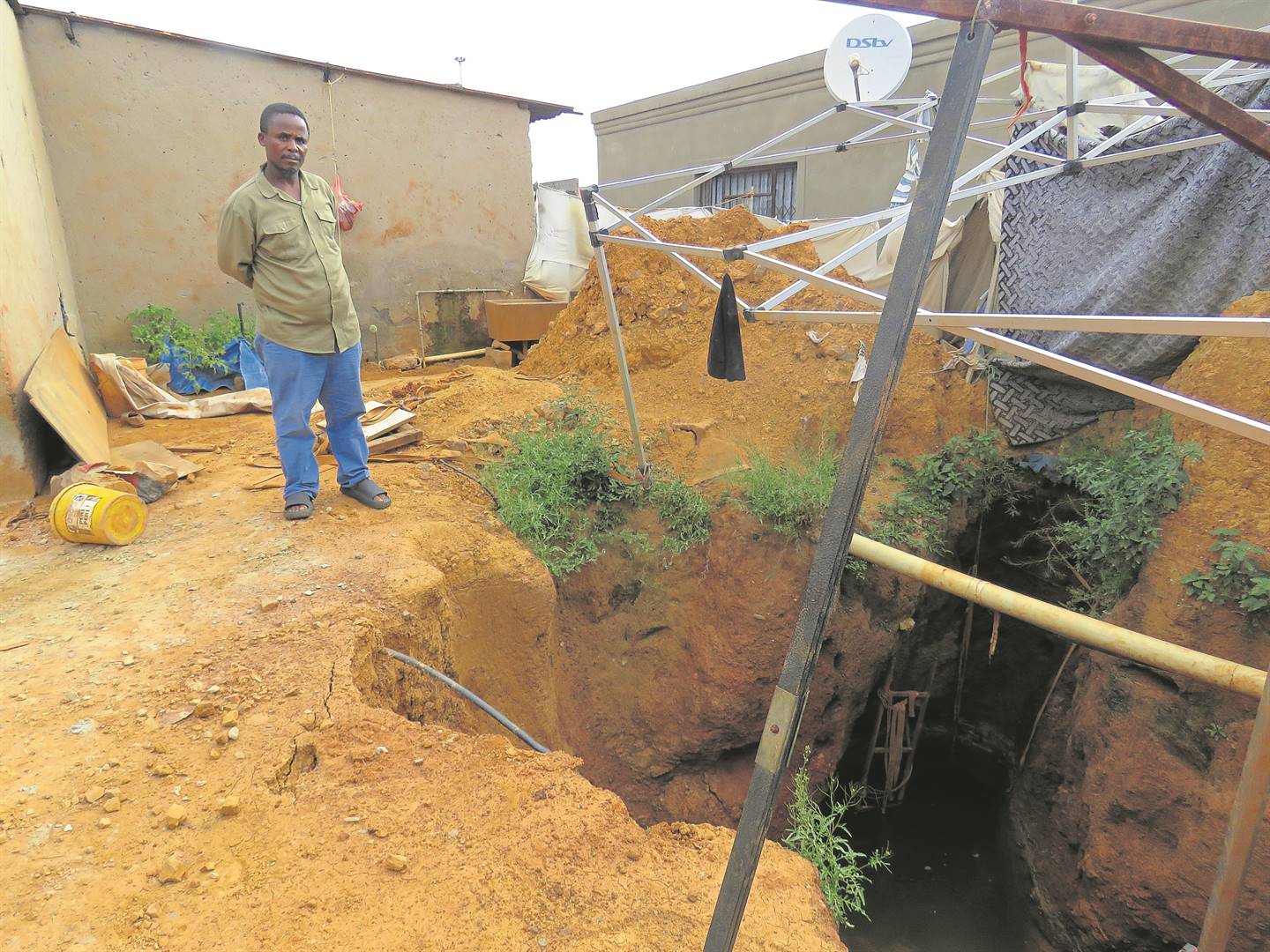 This huge hole that Mthetho Makhathini has dug up in his yard is a big headache for neighbours.   Photo by             Ntebatse Masipa