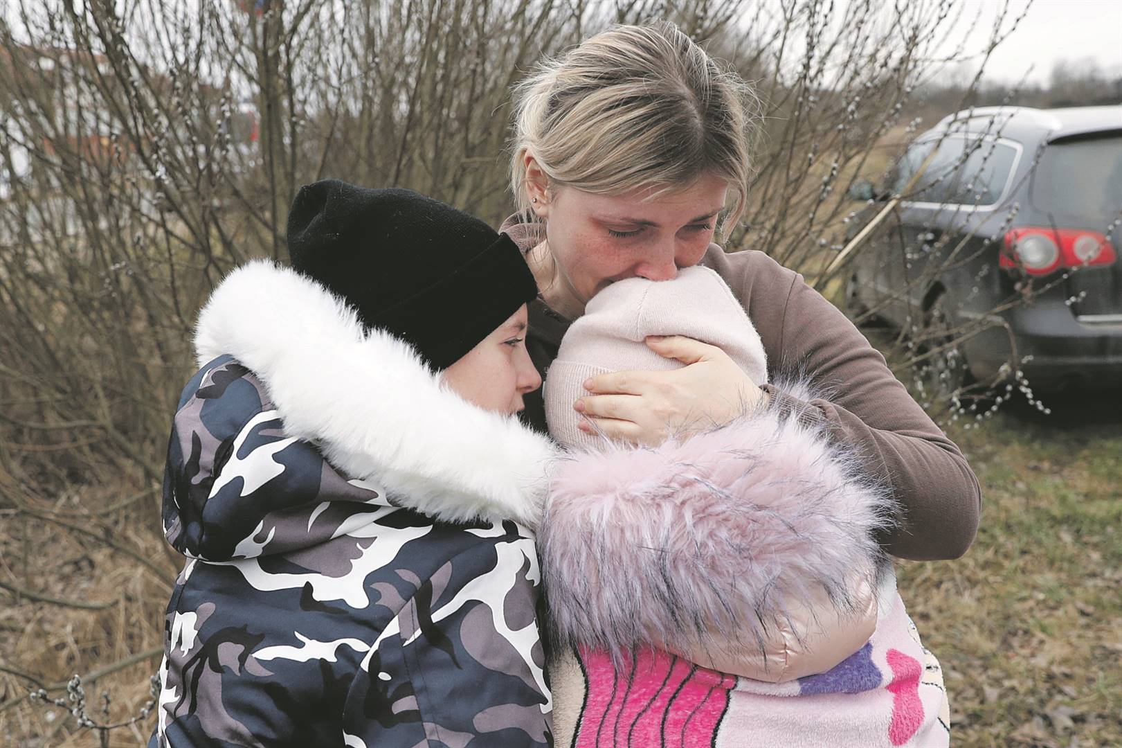 Anna Semyuk (33) hugs her children after a stranger took them across the border to safety in Hungary. They fled Ukraine after Russian invaded their country. Photo: Reuters