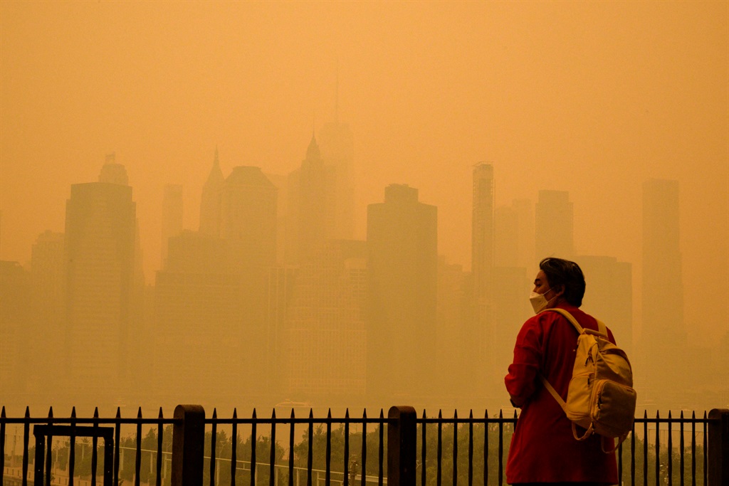 A person wears a face mask as smoke from wildfires in Canada cause hazy conditions in New York City on 7 June 2023. 
