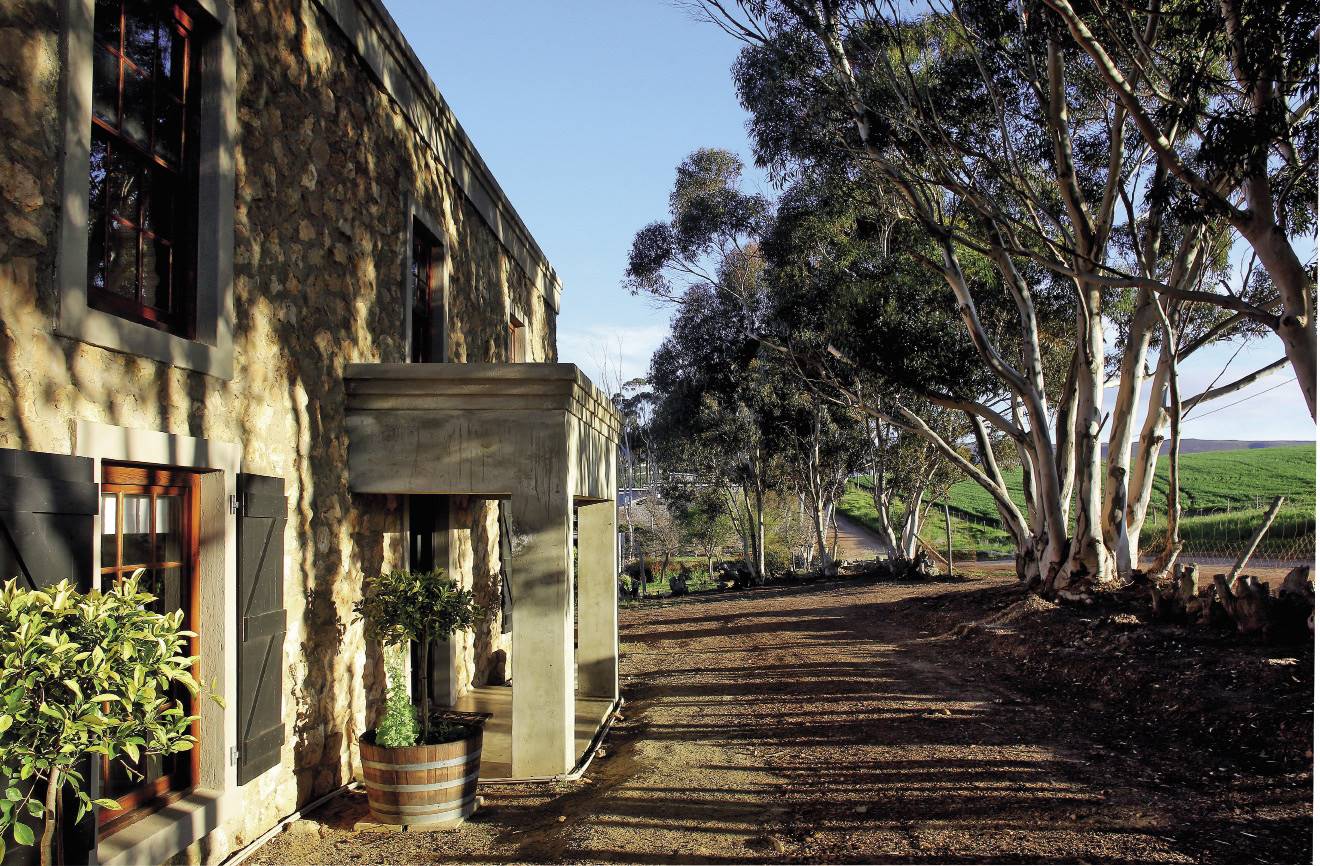 The Oppermans fell in love with the blue gum trees. “The dappled light they create on the stone walls is very peaceful, while the breeze whispering gently through the branches is also very soothing,” says Renette. The couple made the shutters for their home’s façade from old floorboards.