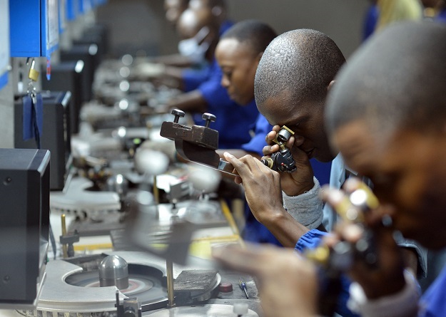 Workers check, cut and polish diamonds at a Diamond cutting and polishing company in Gaborone.