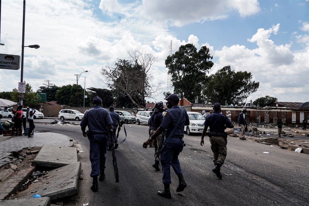 Police patrol the streets of Alexandra following two days of protests over businesses owned by foreign nationals.