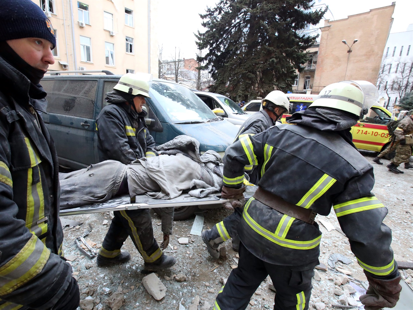 Rescuers carry a wounded person on the stretcher as they respond to shelling by Russian troops of central Kharkiv, northeastern Ukraine, on March 1, 2022.