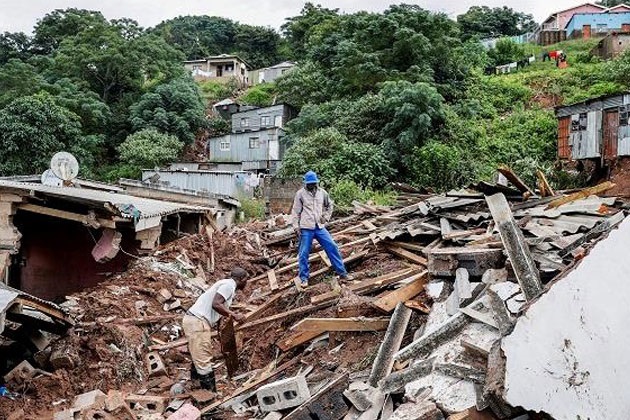 Residents salvage the remains of destroyed buildings in Clermont, near Durban. PHILL MAGAKOE / AFP