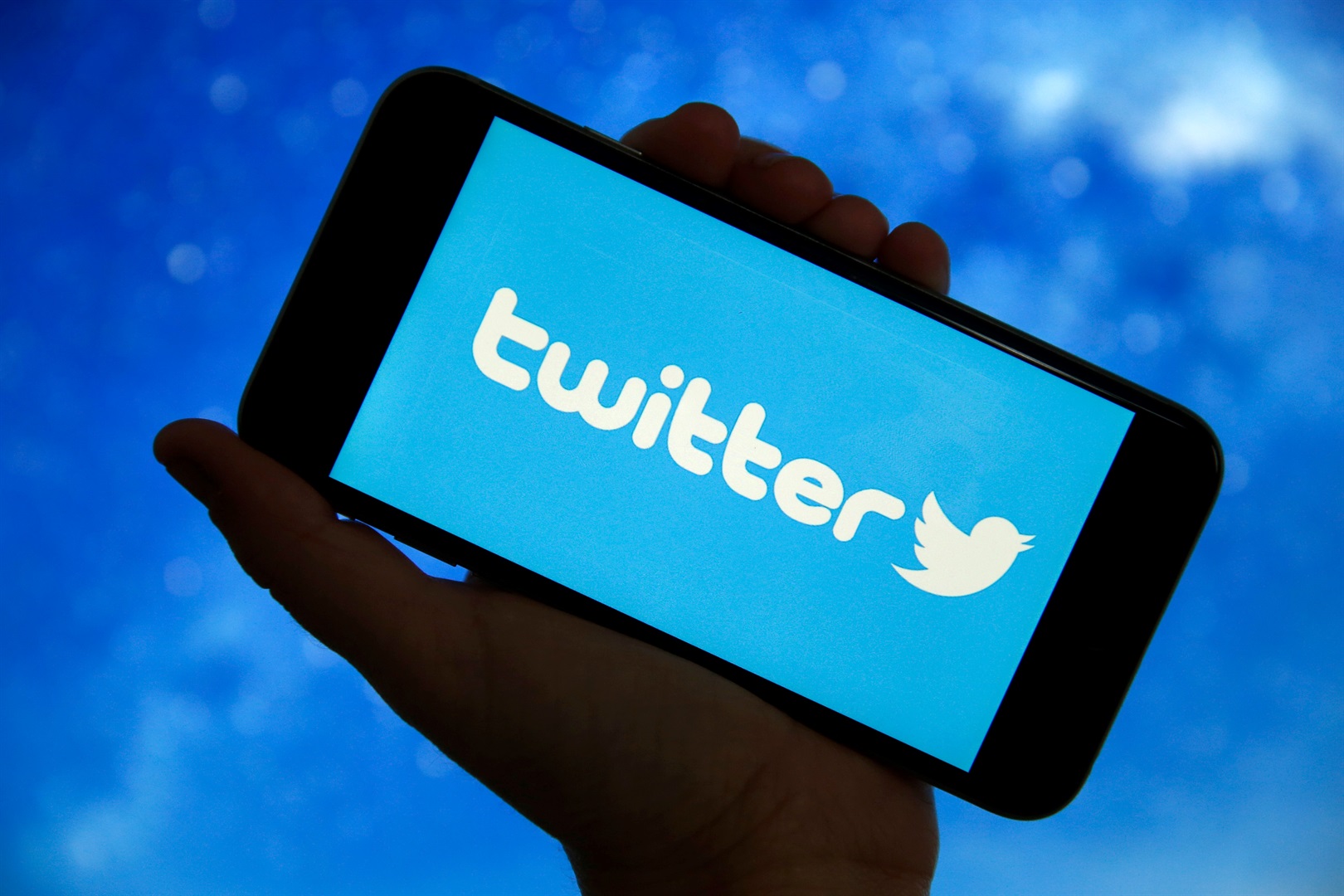Twitter logo is displayed on the screen of a smartphone. Chesnot/Getty Images
