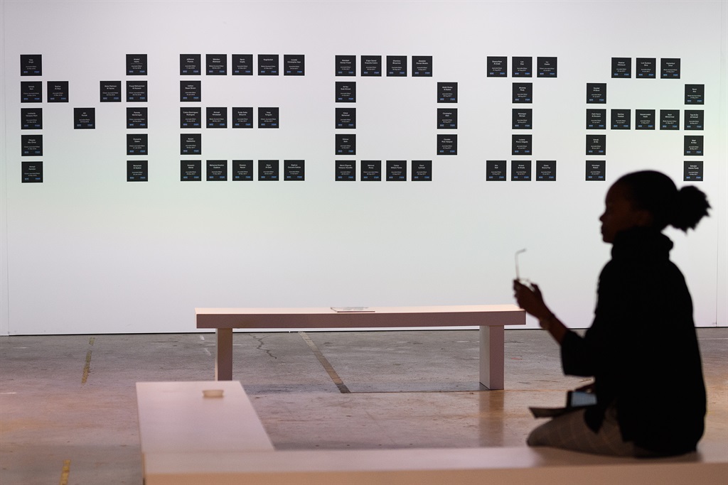 A woman sits in front of a display made up of the names of murdered journalists, at the Global Conference on Press Freedom on July 10, 2019 in London, England. (Photo by Leon Neal/Getty Images)