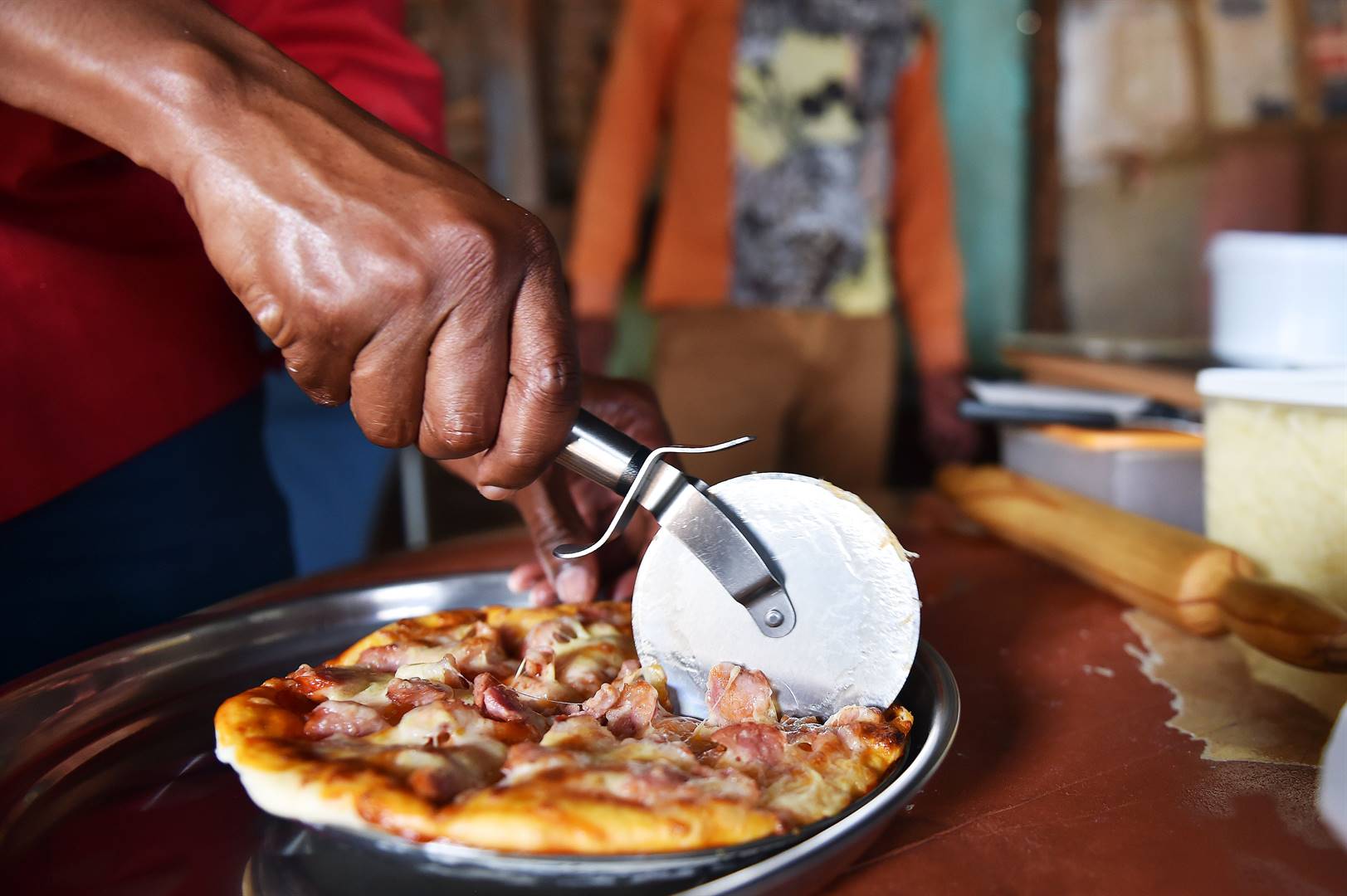 INSET: Pizza man Thamba Limekhaya makes mouthwatering pizza from back yard shack in Orange Farm, south of Joburg. Photo by Christopher MoagiPhoto by 