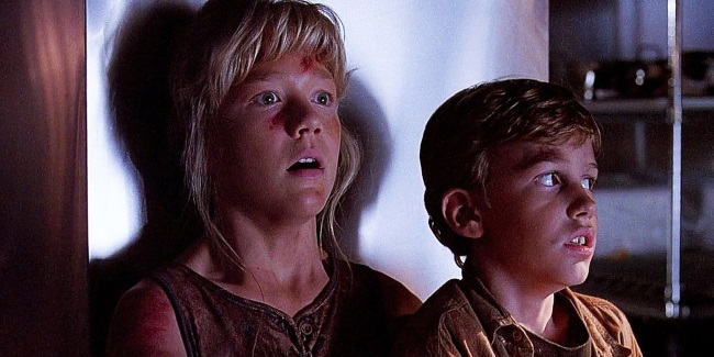 Ariana Richards and Joseph Mazzello hide from the dinosaurs in the original Jurassic Park.
(Photo: UNIVERSAL)