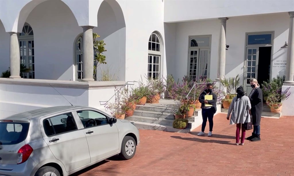 Social workers arrive at the Dorp Hotel in Schotsche Kloof, Cape Town on Tuesday to conduct a safety inspection of Die Antwoord's biological child.