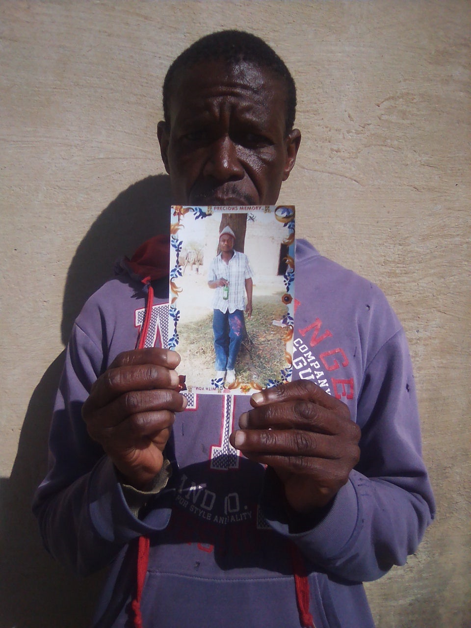 Matserana Mokoena holding the photo of Abram said the family is very devastated. Photo by Bongani Mthimunye 