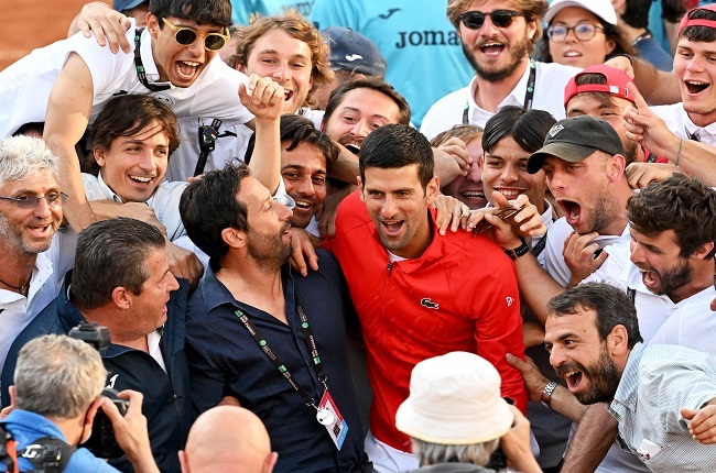 Novak Djokovic and fans. (Photo by Tiziana FABI / AFP)