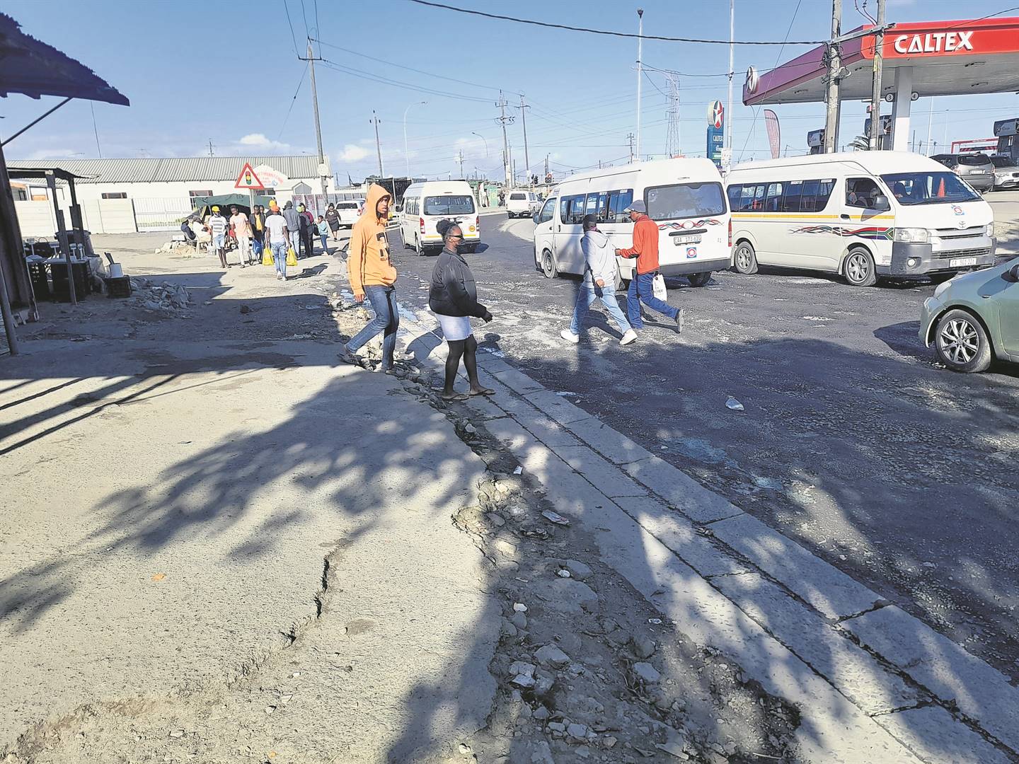 Taxi drivers and vendors struggled to work because of pools of the sewage flowing on the main road that leads to Site C Taxi Rank.        Photos by Misheck Makora 