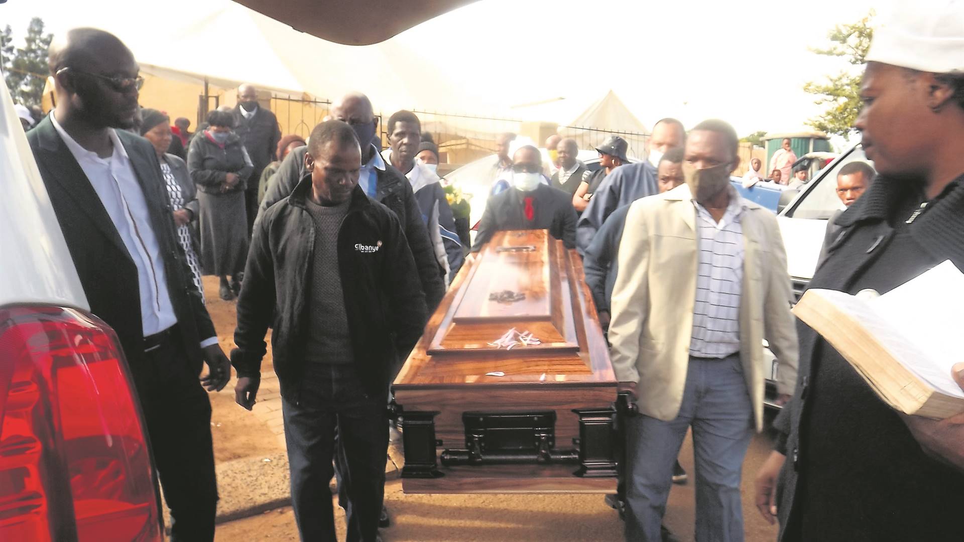 Neighbours, friends and relatives came to pay their last respect to gogo Emily Kubu (inset) in Bekkersdal on Saturday, 14 May.            Photos by Sammy Moretsi