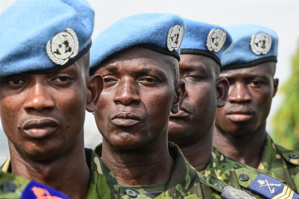 Four Ivorian soldiers belonging to the United Nations Multidimensional Integrated Stabilisation Mission in Mali (MINUSMA) stand during a decoration ceremony at Camp Gallieni in Abidjan.