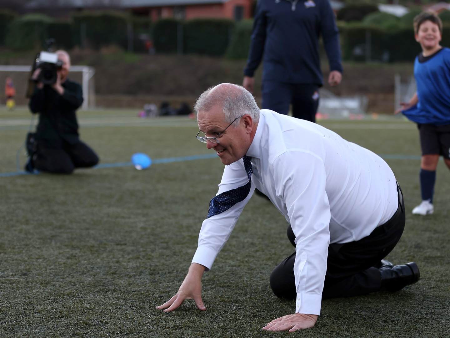 Prime Minister Scott Morrison falls over after accidentally knocking over a child during a visit to the Devonport Strikers Soccer Club, which is in the electorate of Braddon, on May 18, 2022 in Devonport, Australia. Photo by Asanka Ratnayake/Getty Images