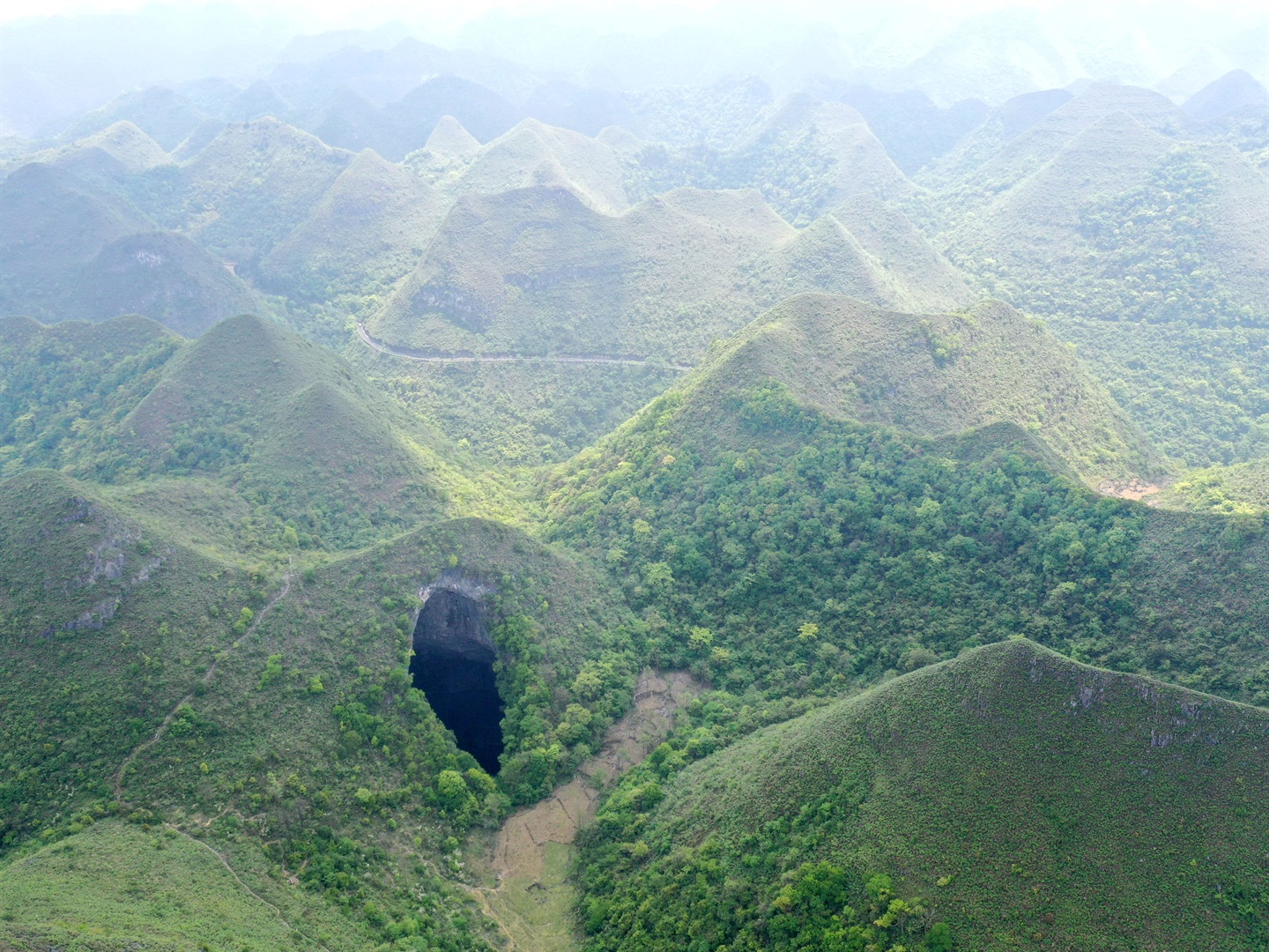 A Tiankeng, or giant karst sinkhole, at Leye-Fengshan Global Geopark, China's Guangxi Zhuang Autonomous Region. Zhou Hua/Xinhua via Getty Images.