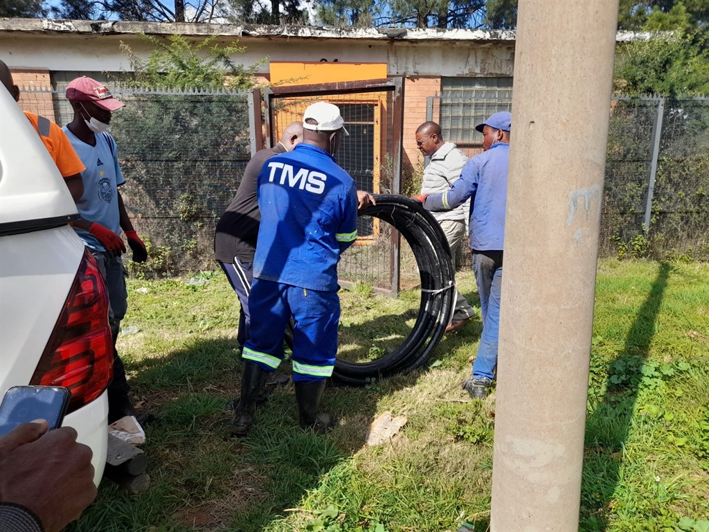 Emfuleni workers with a new copper cable to replace the stolen one.