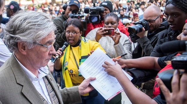 <em>Stellenbosch Uni's VC, Prof Wim de Villiers, receives the demands from students during a march against racism at the university on Thursday. (Gallo Images/Brenton Geach)</em>