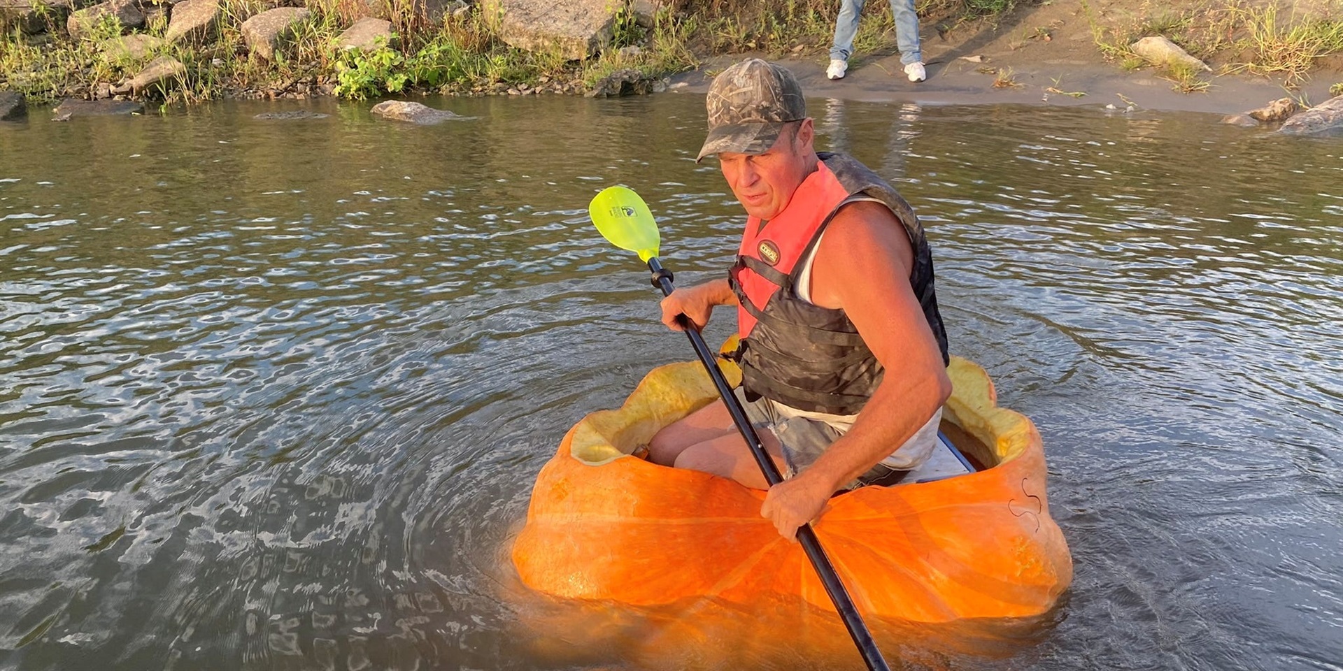 A man floats down the Missouri river in a giant hollowed out pumpkin, in Be...