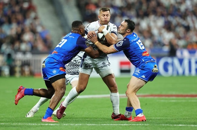 Handre Pollard of Montpellier is tackled by Adrea Cocagi and Thomas Combezou during the Final Top 14 match between Castres Olympique and Montpellier Herault Rugby at Stade de France on June 24. (Getty Images)