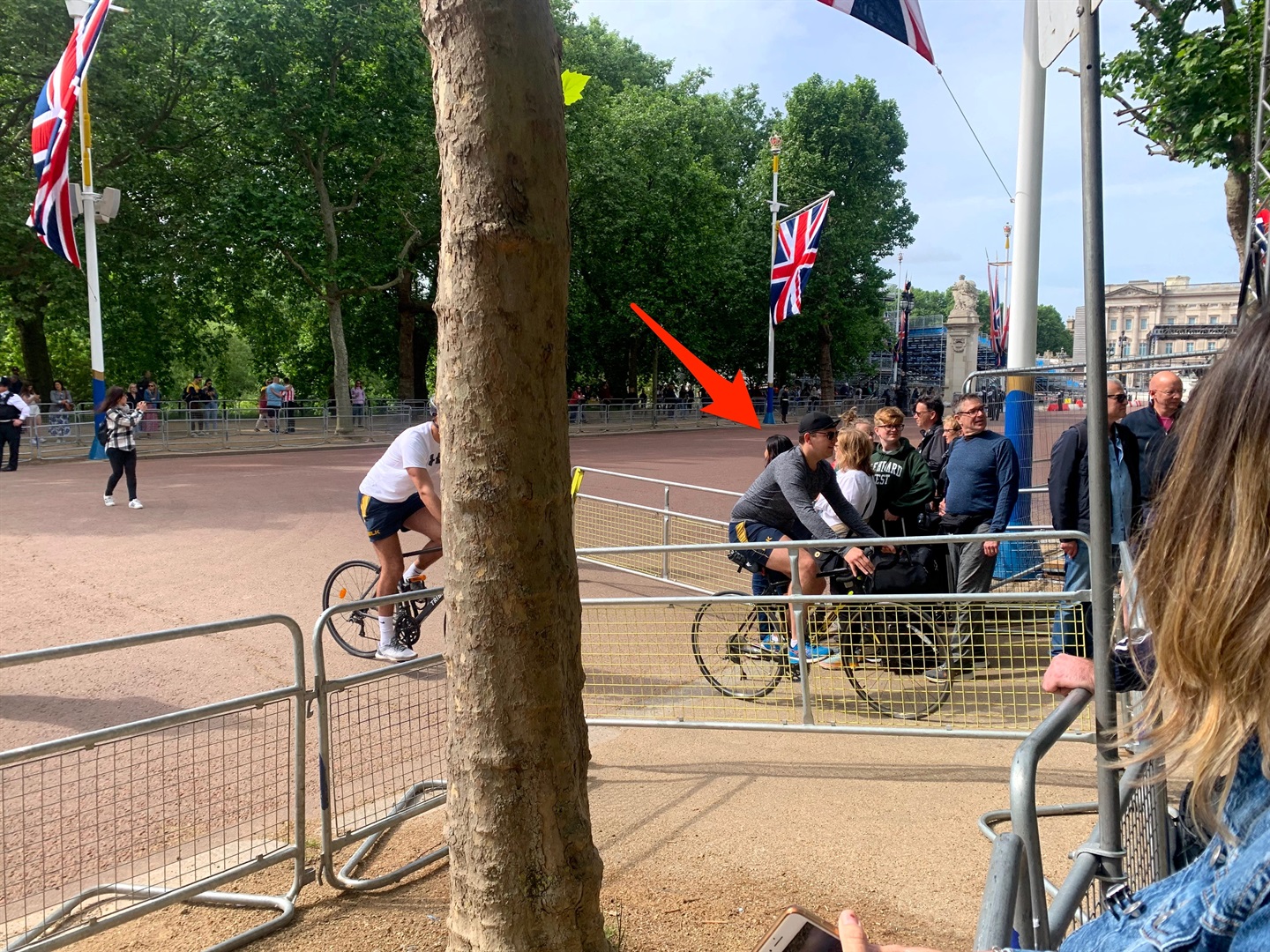 Cyclists trying to weave past royal spectators.