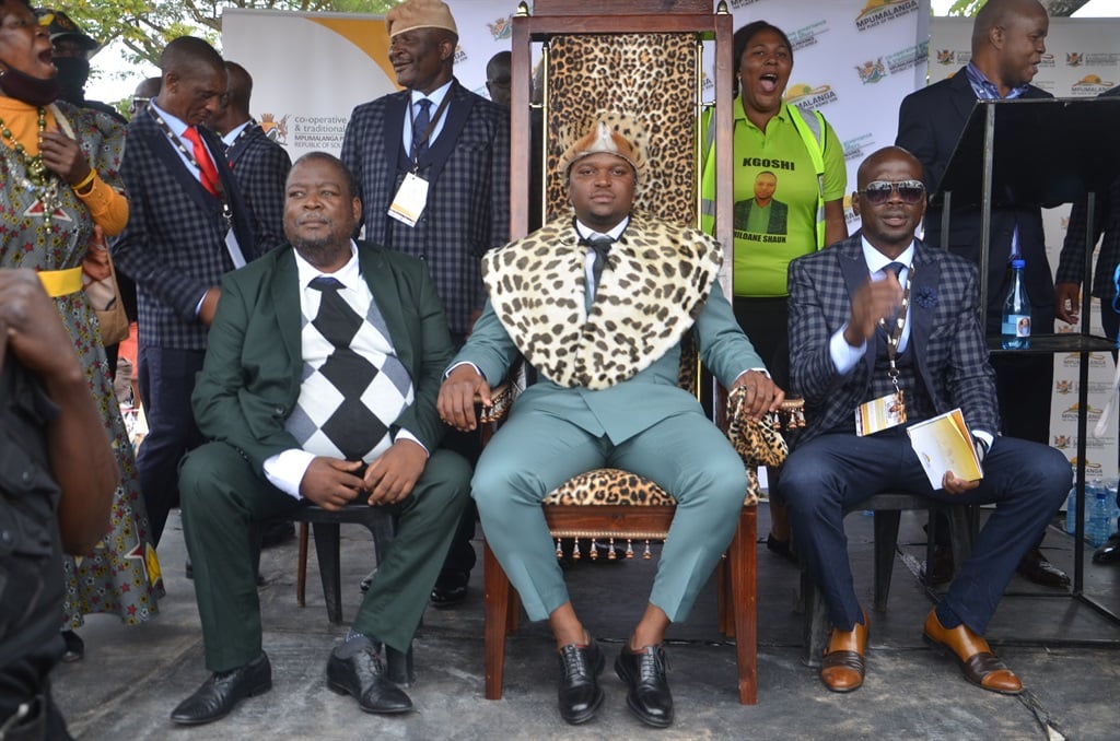 Kgoshi Shaun Chiloane on his throne (centre seated) flanked by his royal family members as Cogta MEC Mandla Ndlovu hand over his certificate (far right on addressing with a mic) 
Photos By Oris Mnisi 
