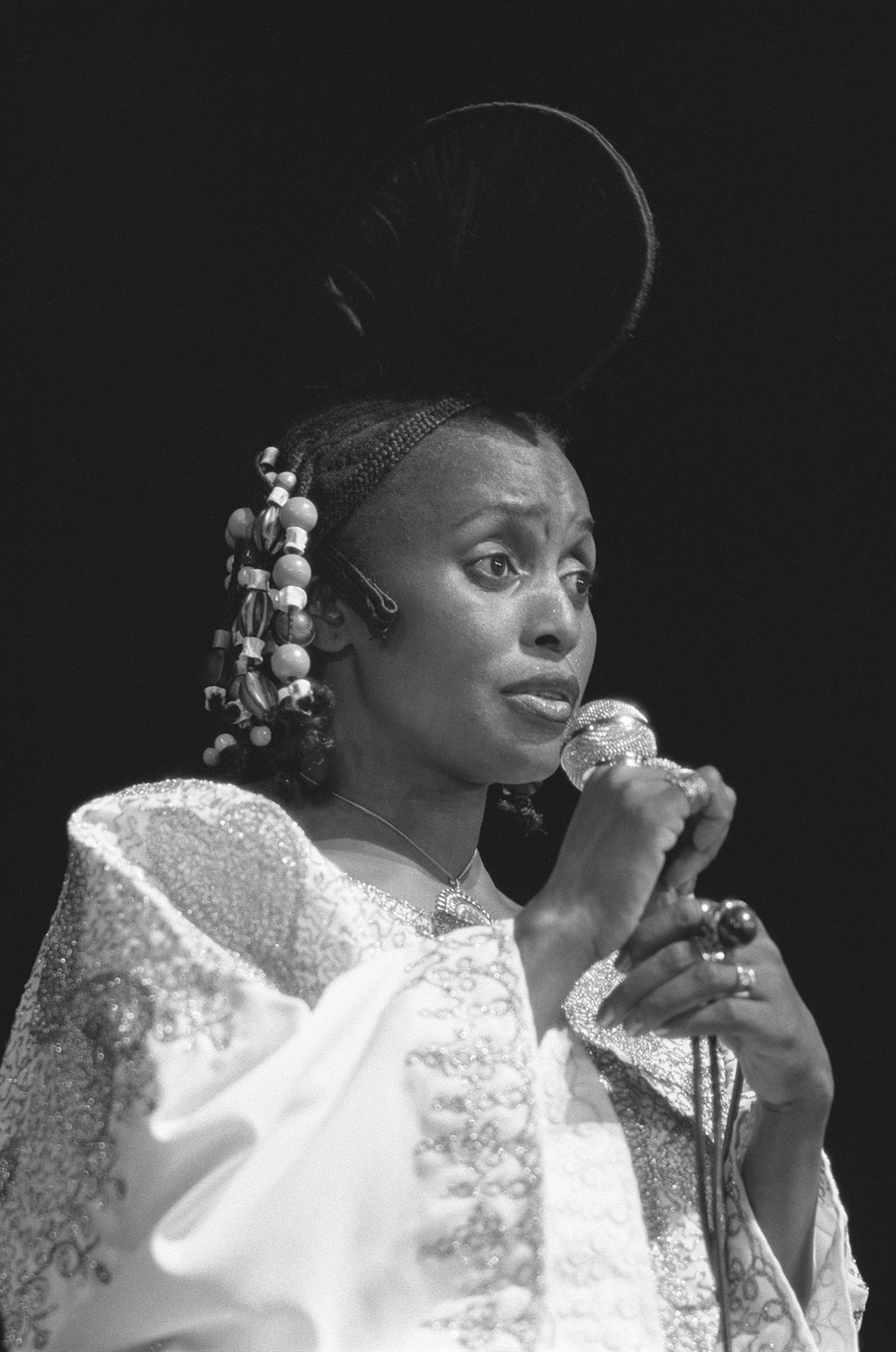 The late Miriam Makeba in beaded cornrows with a b