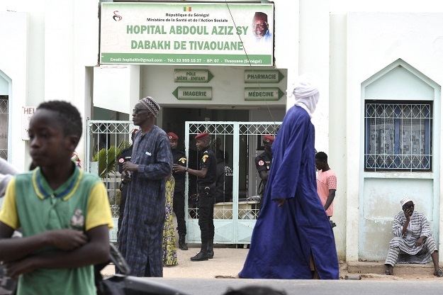 Visitors stand in front of the Mame Abdoul Aziz Sy Dabakh Hospital, where eleven babies died following an electrical fault, in Tivaouane, Senegal.