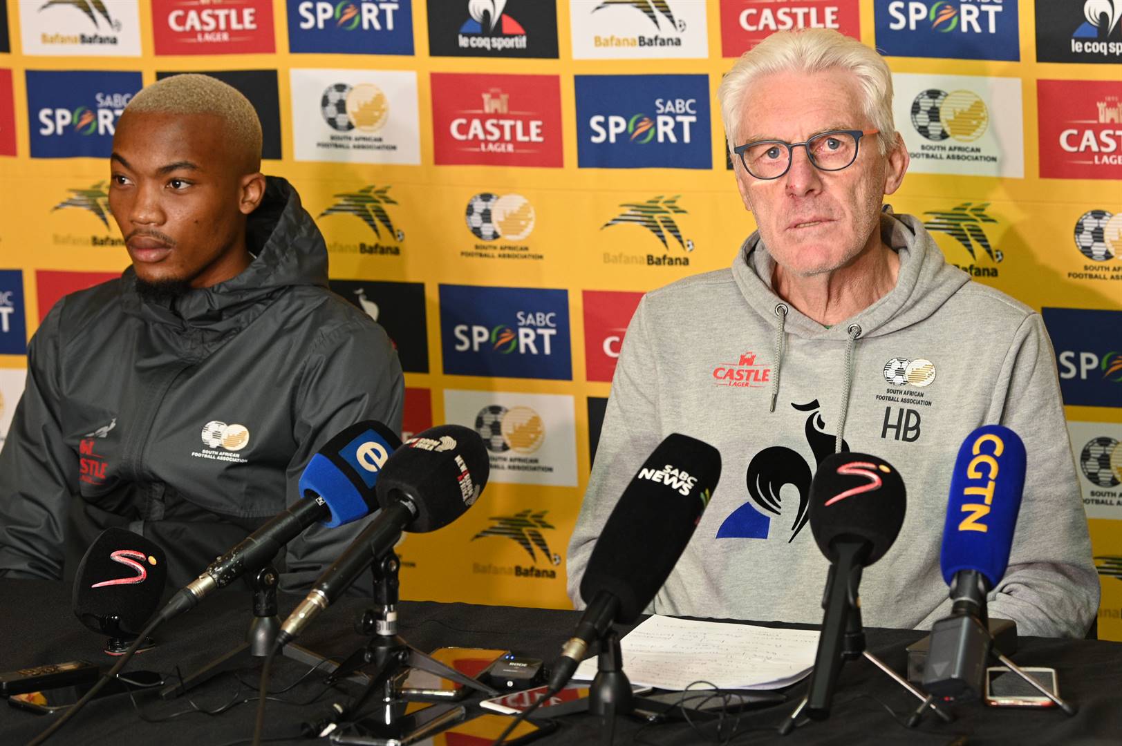 Bafana head coach Hugo Broos, flanked by the team’s new call-up Khanyisa Mayo, addressing the media during a predeparture conference at Sturrock Park in Johannesburg on Wednesday. Photo: Lee Warren/Gallo Images 
