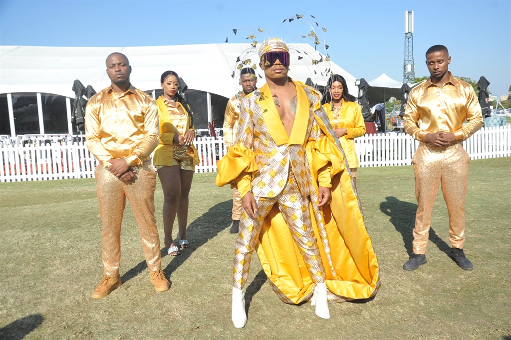 Media personality made a grand entrance with his crew wearing gold showing honey in Durban July. Photo by Jabulani Langa