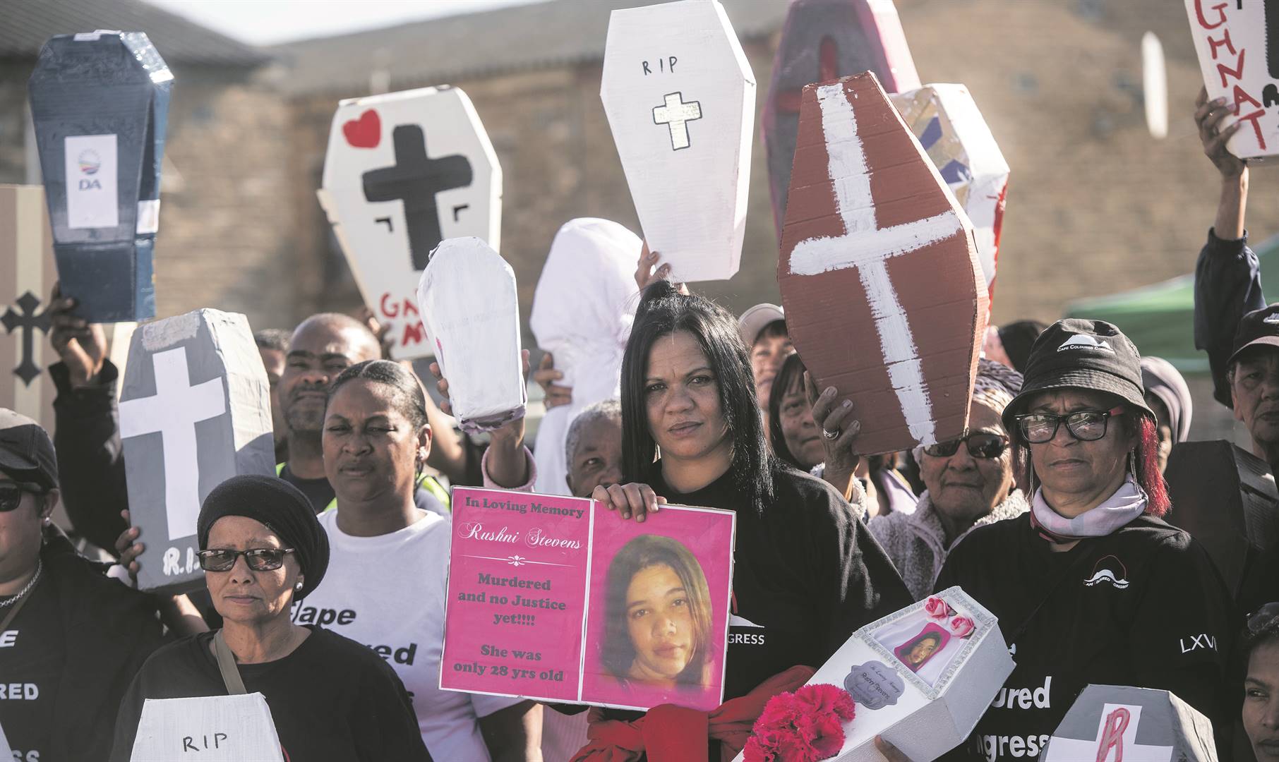 Families and members of the Cape Coloured Party in the Western Cape gather on Saturday opposite the Manenberg Police Station in Cape Town with coffins representing the young people killed in gang violence in the province. They staged the protest the day after Police Minister Bheki Cele released the newest crime statistics on Friday. Photo: Gallo Images