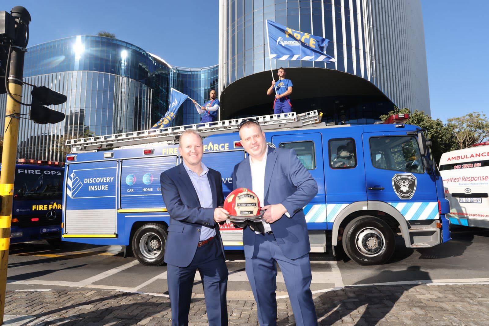 Anton Ossip, from Discovery Insure, and Hadley Shapiro of Advanced EMS, in front of the new Discovery Insure fire trucks Photo: Supplied