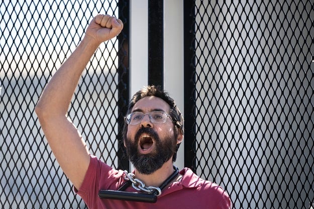 Abortion rights activist Guido Reichstadter chains himself to a security fence in front of the US Supreme Court.