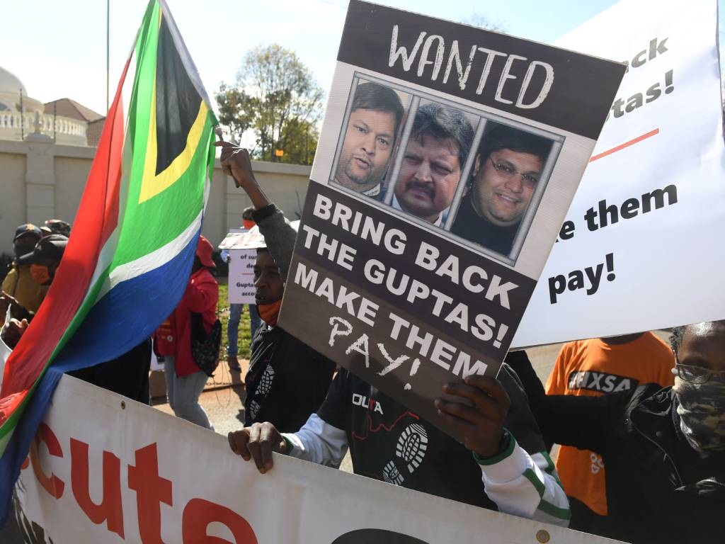 A group of people protest outside the United Arab Emirates' (UAE) embassy calling for the speedy extradition of the Guptas in 2021.