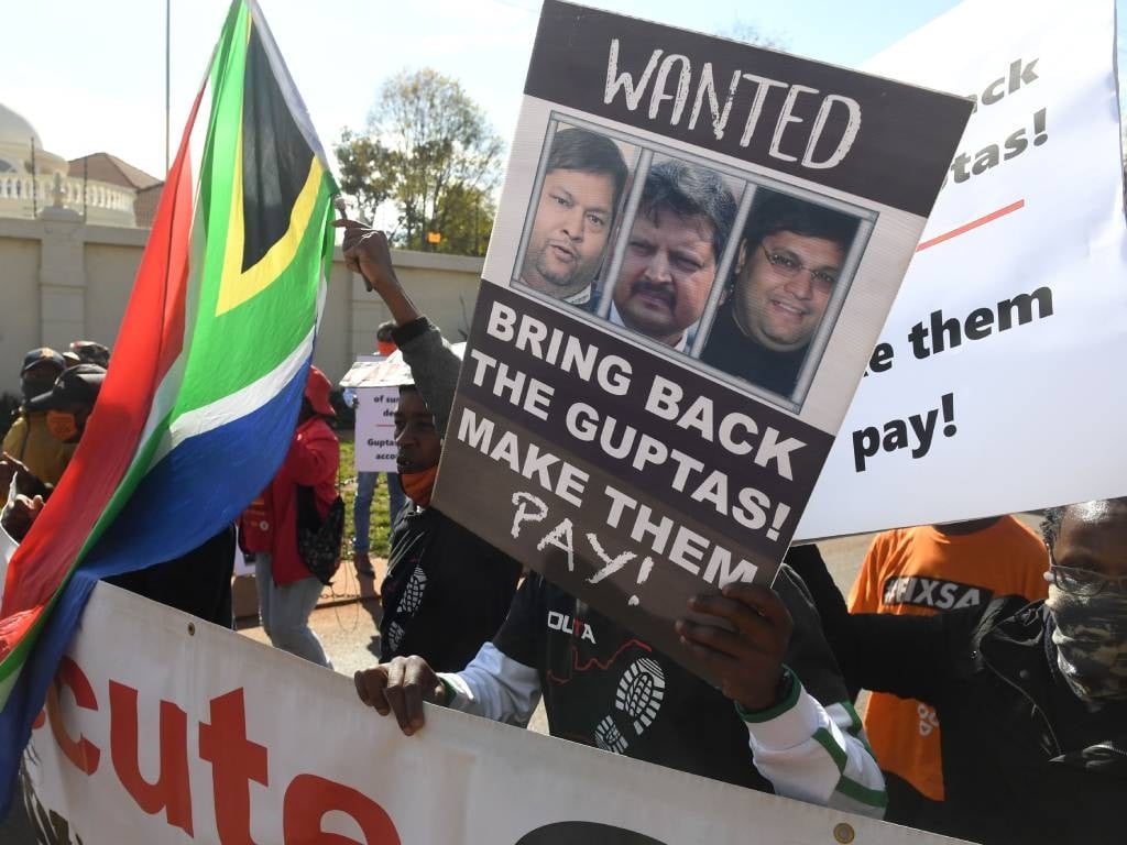 A group of people protest outside the United Arab Emirates' (UAE) embassy calling for the speedy extradition of the Guptas. File Photo.