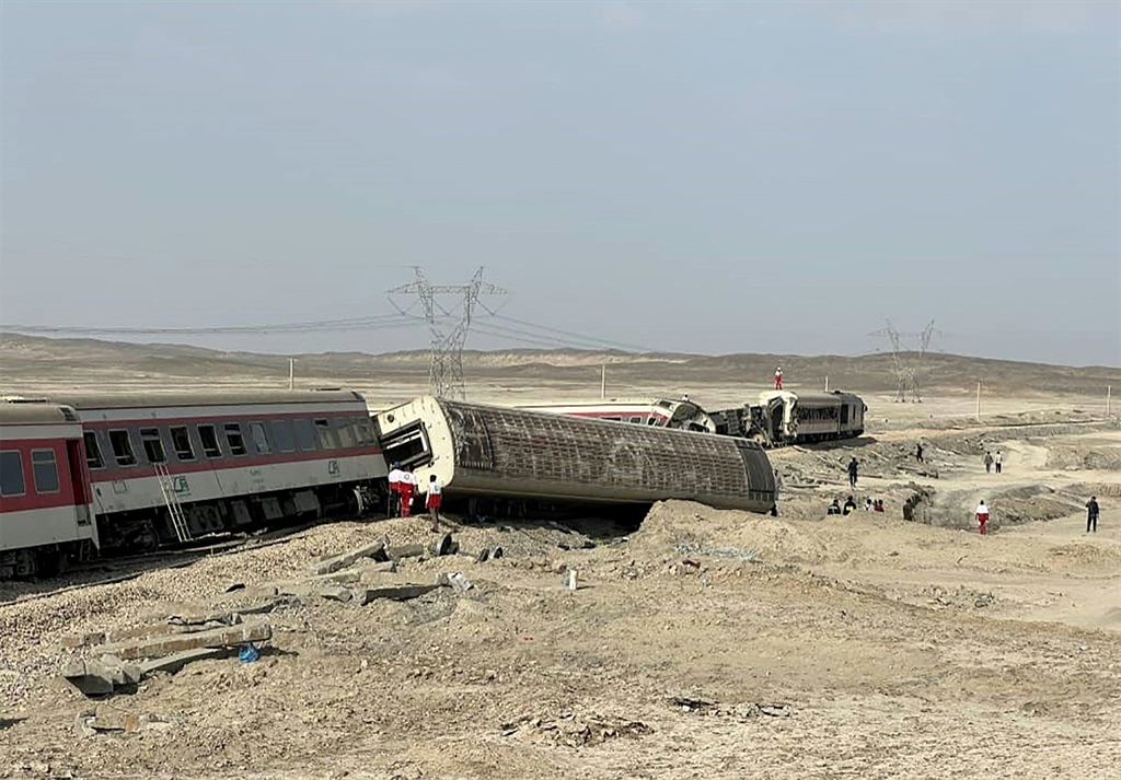 A handout picture made available by the Iranian Red Crescent on June 8, 2022 shows rescuers at the scene of a train derailment near the central Iranian city of Tabas on the line between the Iranian cities of Mashhad and Yazd.