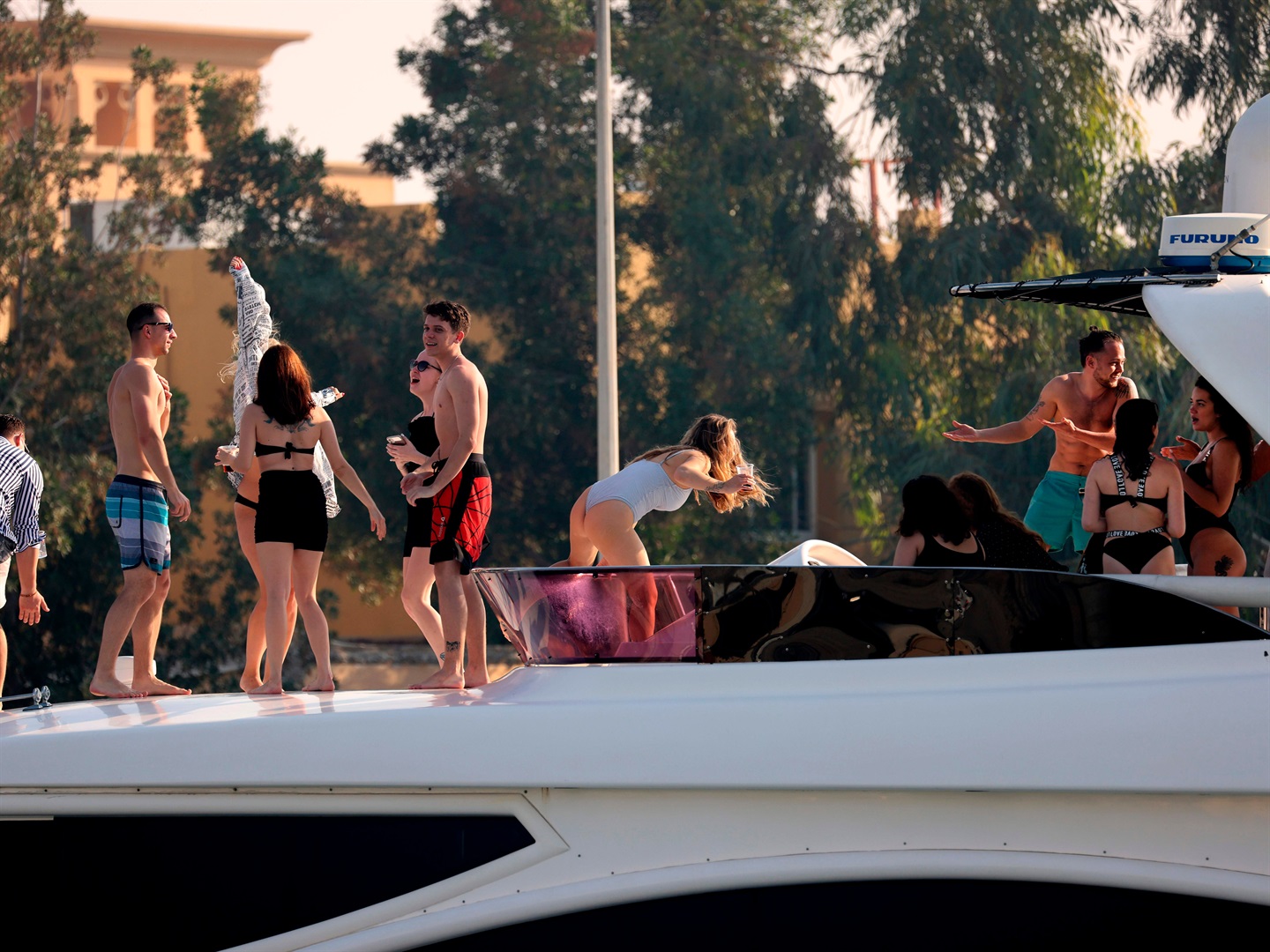 Expats partying on a luxury yacht docked on Dubai creek. KARIM SAHIB/AFP via Getty Images