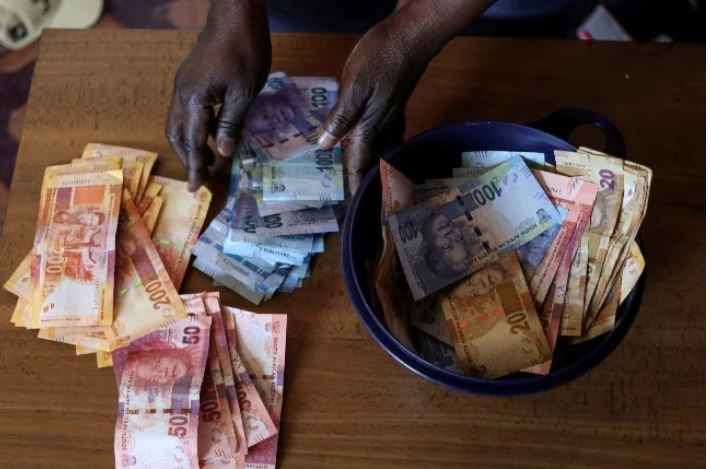 A stokvel cub member counts banknotes.
Gallo Images