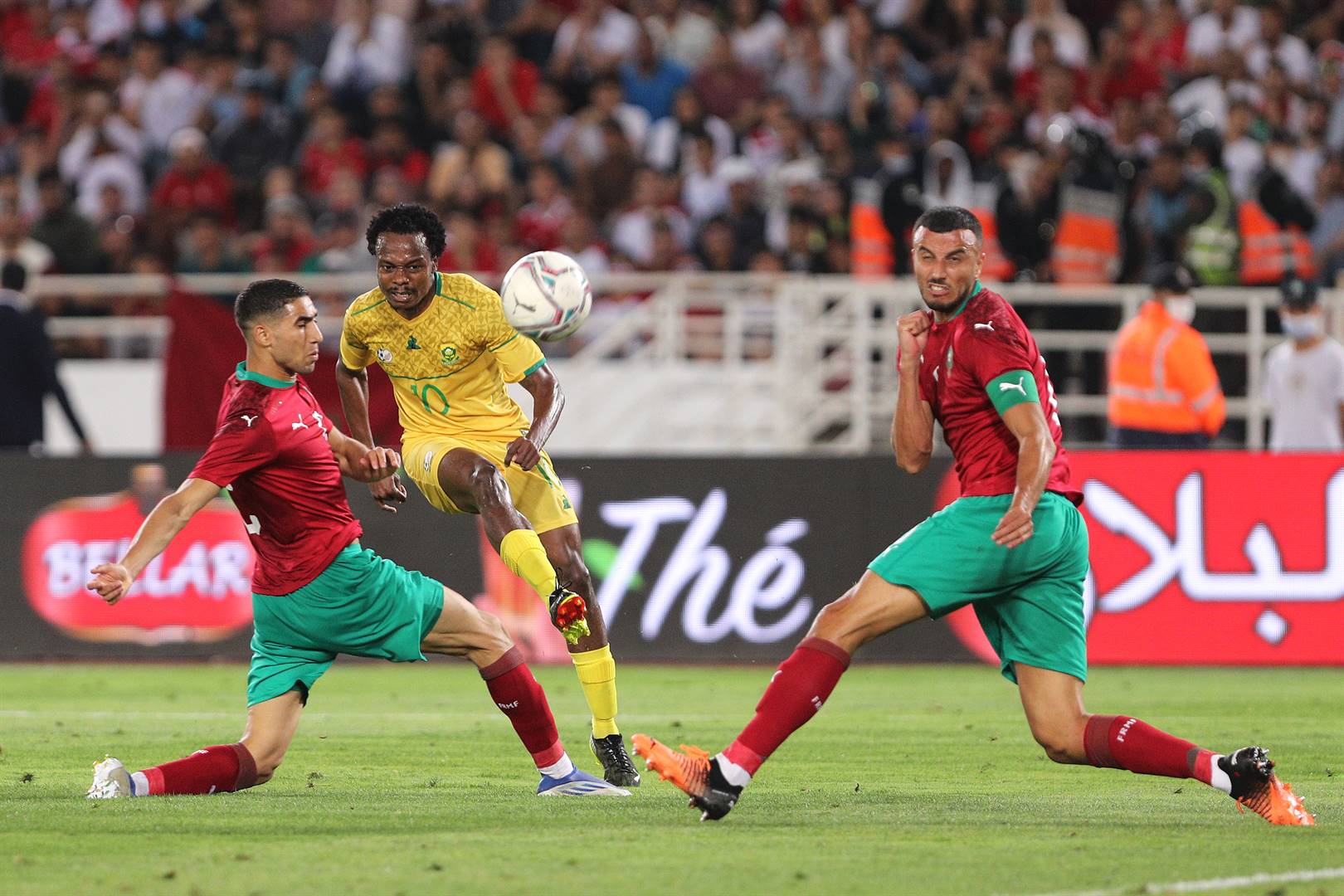 Percy Tau squeezes a shot at goal under the attention of Morocco defenders during the two nations’ Afcon qualifier at the Stade Prince Moulay Abdallah in Rabat on Thursday. Photo: Nour Akanja/BackpagePix 
