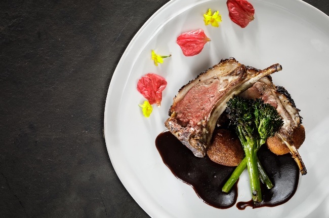The roasted dad’s braaied lamb rack, pumpkin fritters, fire-grilled broccolini and red wine jus
