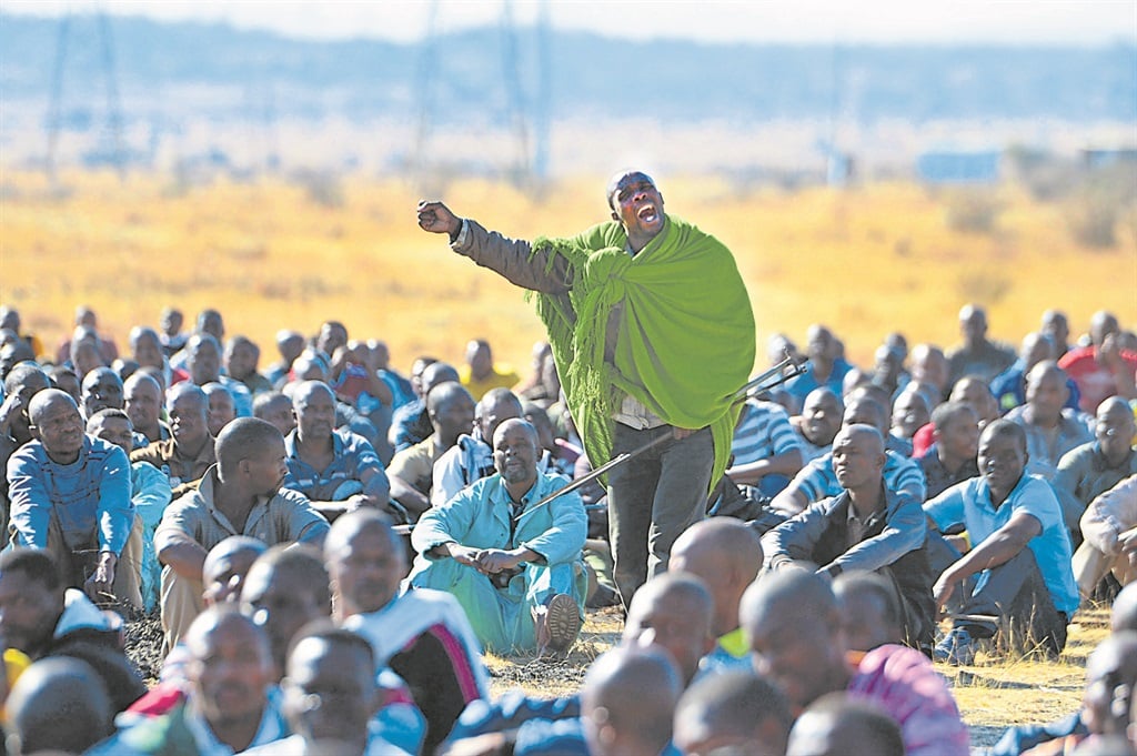 Strike leader Mgcineni Noki, also known as the man in green blanket, rallies the miners at Marikana ahead of their encounter with police that left 34 miners dead, shot by the police. Photo: Leon Sadiki 