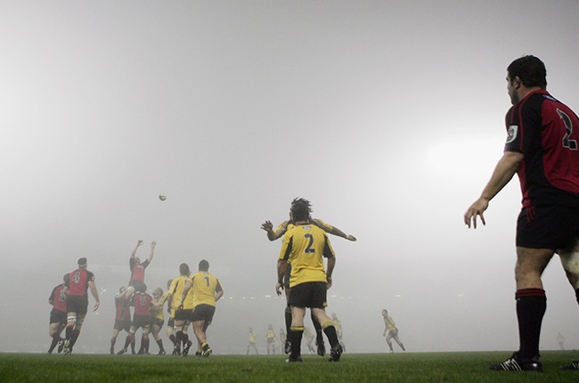 Cory Flynn of the Crusaders (R) throws into the lineout ball in foggy conditions during the Super 14 final match against the Hurricanes at Jade Stadium May 27, 2006 in Christchurch. (Photo by Ross Land/Getty Images)